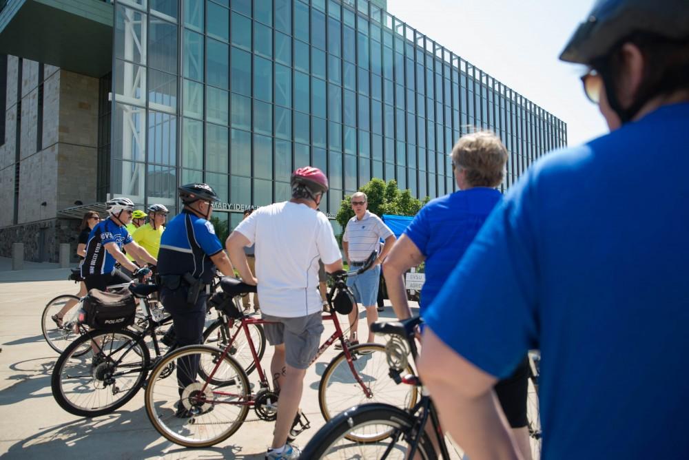 GVL / Luke Holmes - Students and faculty gather outside the Mary Idema Pew Library on their bikes. Bike Ride With T Haas was held Monday, June 12, 2017 to kickoff Active Commute Week.