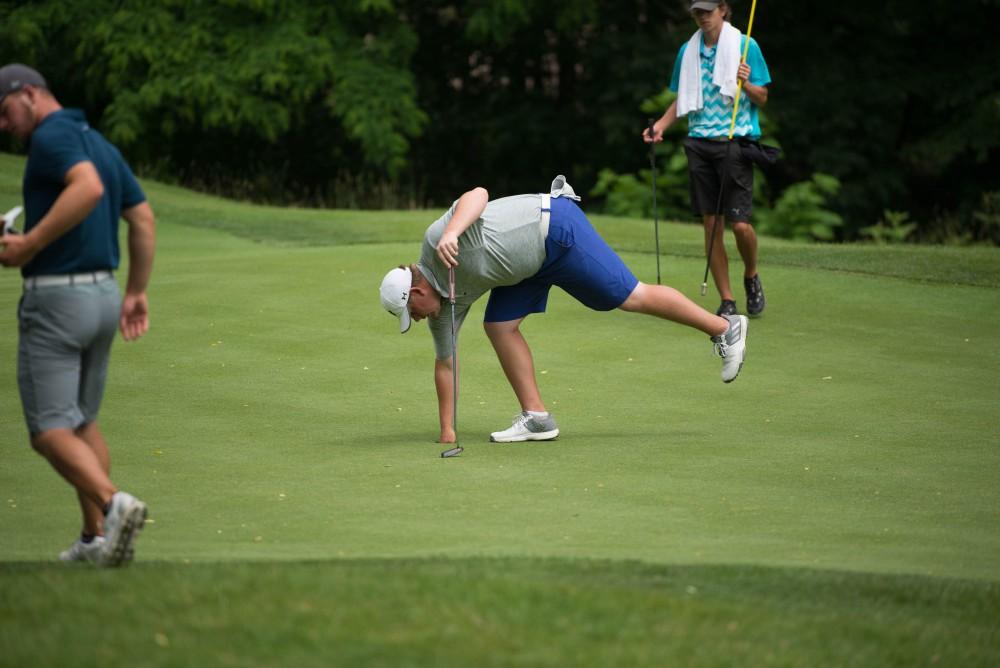 GVL / Luke Holmes - Chad Johnson picks his ball out of the cup. The first round of match play for the Michigan Amateur was held at Egypt Valley Country Club on Thursday, June 22, 2017.