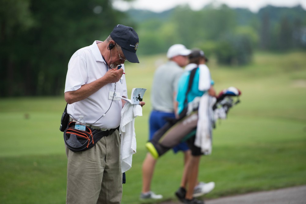 GVL / Luke Holmes - GAM volunteer, Thomas Hamilton, radios in the current standing of the match. The first round of match play for the Michigan Amateur was held at Egypt Valley Country Club on Thursday, June 22, 2017.