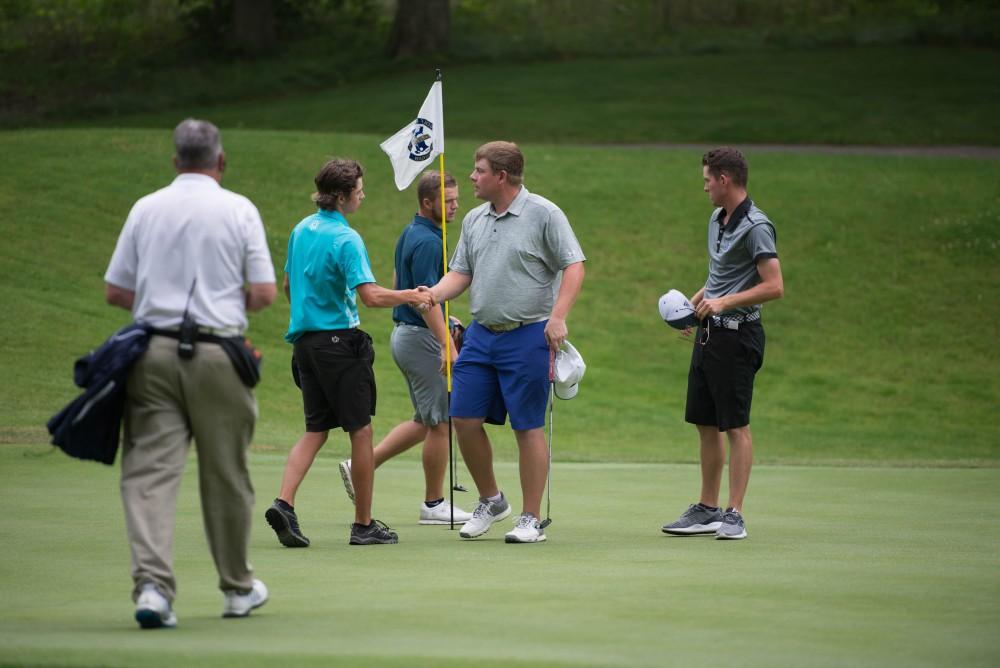 GVL / Luke Holmes - Players shake hands after their match. The first round of match play for the Michigan Amateur was held at Egypt Valley Country Club on Thursday, June 22, 2017.