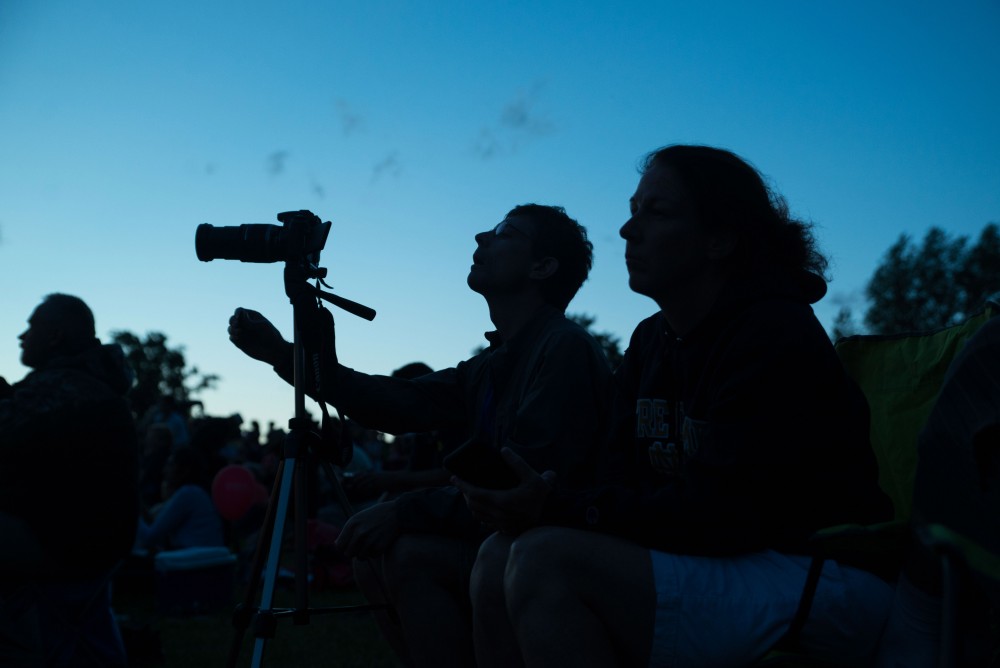 GVL / Luke Holmes - A man positions his tripod to photograph the balloons. The Michigan Challenge Balloonfest was held in Howell, MI on Saturday, June 24, 2017.