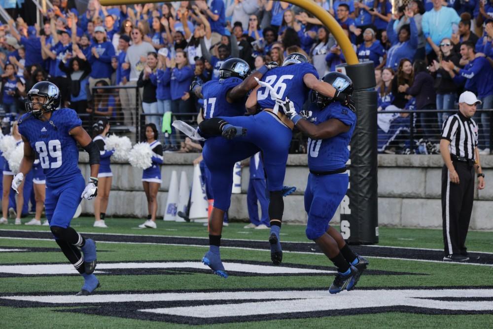 <p>GVL / Emily Frye - Defensive back Eric Plate celebrates GVSU's first touchdown of the game with his teammates Saturday, Sept. 9, 2017. Plate blocked Davenport's punt, allowing Luke DeLong to recover the ball in the end zone for a Laker touchdown. </p>