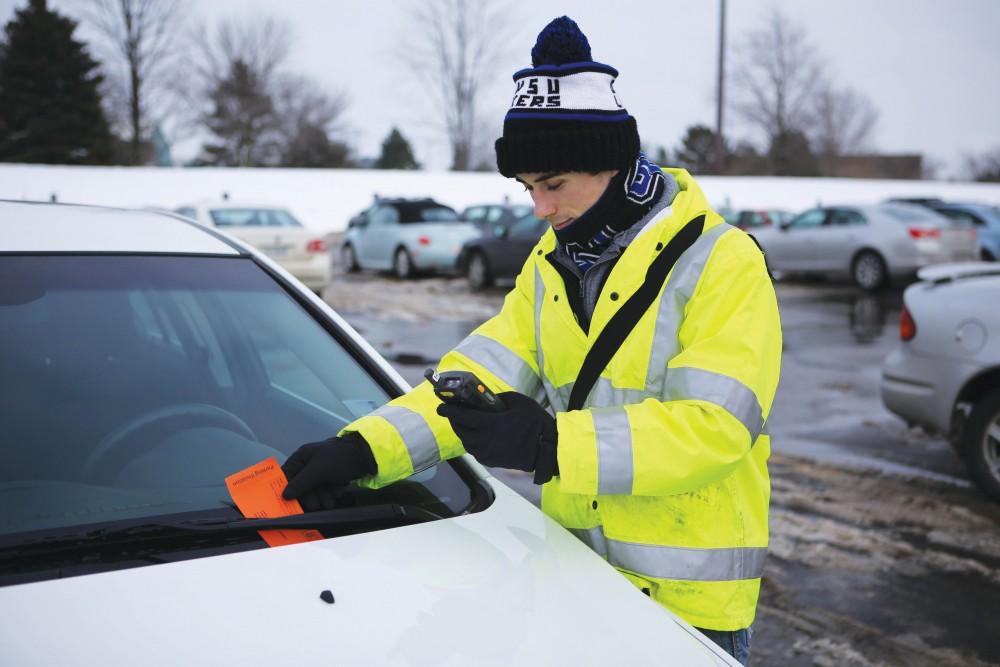GVL / Emily Frye 
Junior Chad Jackson gives out a parking citation to one unlucky student in Lot H on Jan. 23rd.