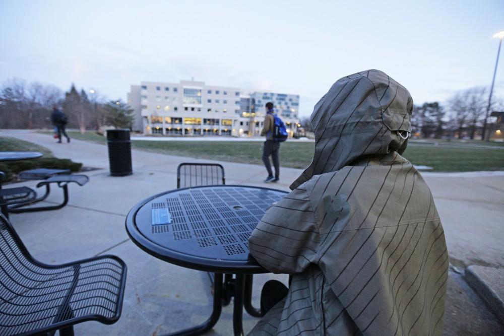 GVL / Emily Frye   GVSU student sits alone outside of Kirkhof center on Wednesday January 24, 2018.