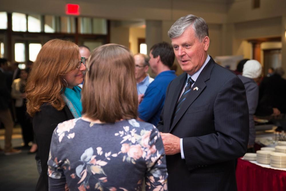 GVL / Luke Holmes - President Haas speaks with a student about the project she runs.The Civic Engagement Showcase was held in the DeVos Center in downtown Grand Rapids on Thursday, April 13, 2017.