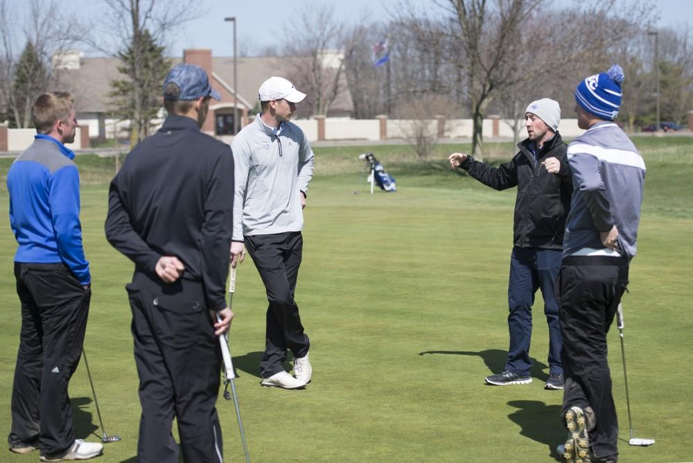GVL / Luke Holmes - Head Coach, Gary Bissell talks to the team on the practice green at The Meadows Golf Course Tuesday, Apr. 5, 2016.
