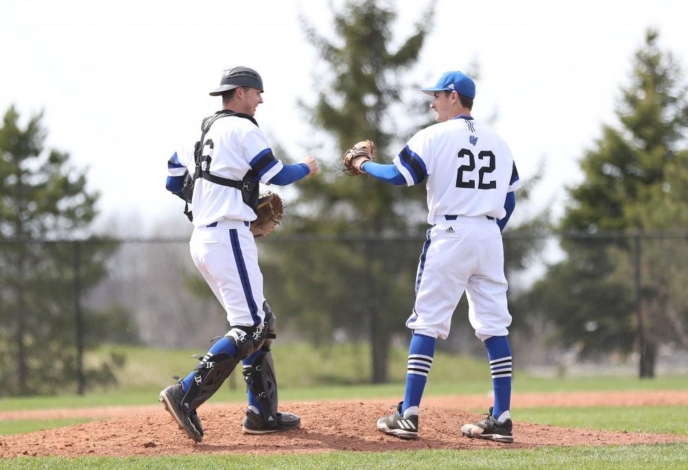 GVL/Kevin Sielaff - Tate Brawley (22) and Connor Glick (16) fist bump at the mound after closing out an inning during the game vs. Ashland on Wednesday, April 12, 2017.