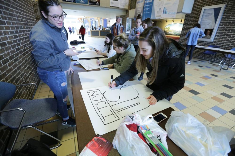 GVL / Emily Frye
GVSU students create signs before participating in a Slut Walk on campus on Saturday April 7th, 2018. 