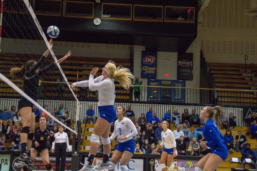 Staci Brower spiking the ball towards Michigan Techs blockers, Friday, Sept. 29, 2017.  GVL / Archive