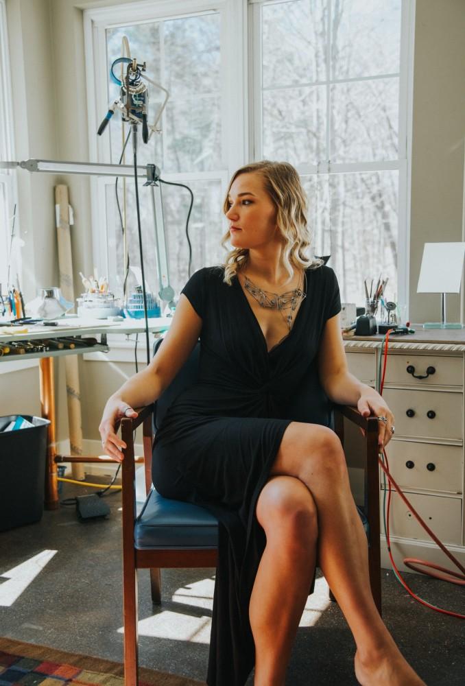 Alumna Emma Hoekstra sits in her studio. Hoekstra placed top five in the Halstead Grant competition because of the successes of her jewelry business. Courtesy  /  Emma Hoekstra