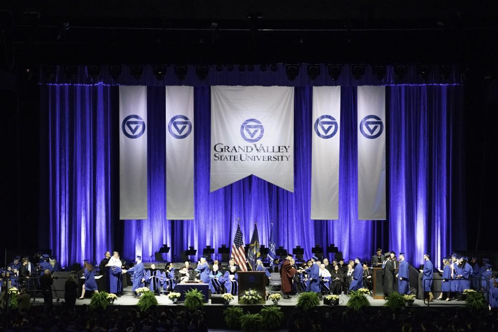 GVL / Andrew Nyhof
Student  walks across stage to recieve their degree.