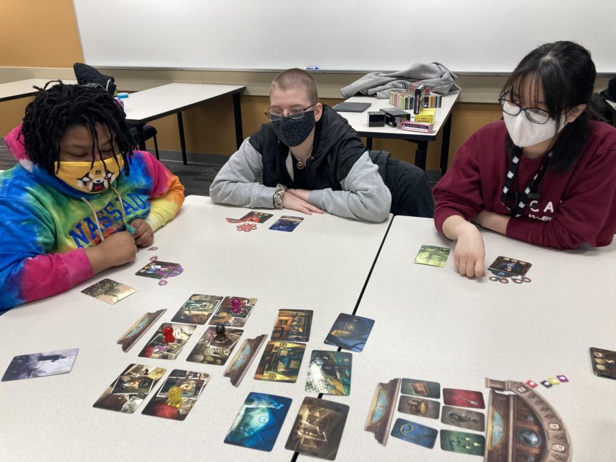 The club playing Mysterium, a co-op game about getting a message across using pictures as clues.(Courtesy Emily Booms)